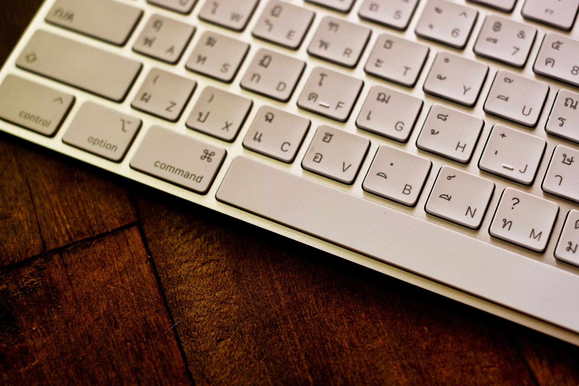 Close-up of a keyboard on a desk, representing focused evening work.