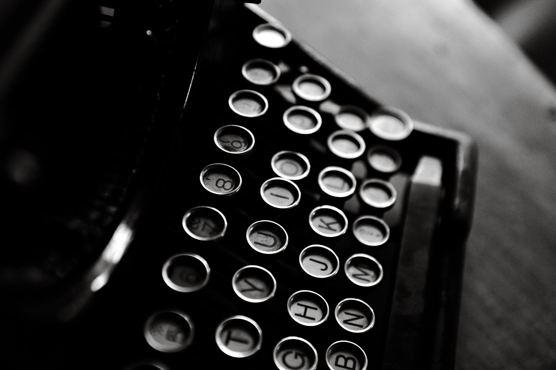 Hands typing on a laptop keyboard, reviewing a document.