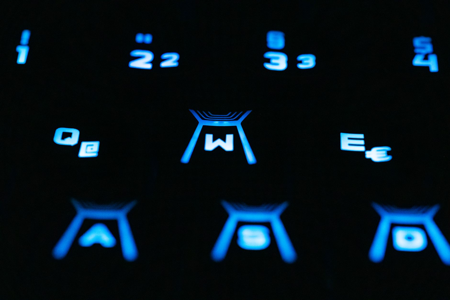 Close-up of a backlit keyboard, used for AI-assisted campaign work.